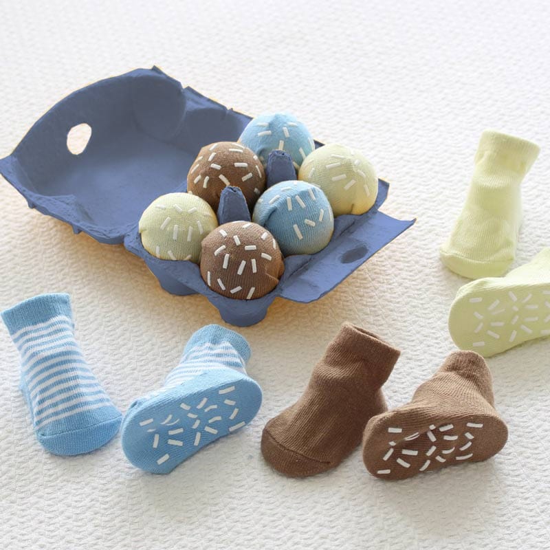 A set of funky baby socks for little boys makes a really special new baby gift. This unusual yet beautiful product contains six pairs of baby socks which have been rolled to look like scoops of ice cream. All this is packed in a real egg box!  Size 0-12 months