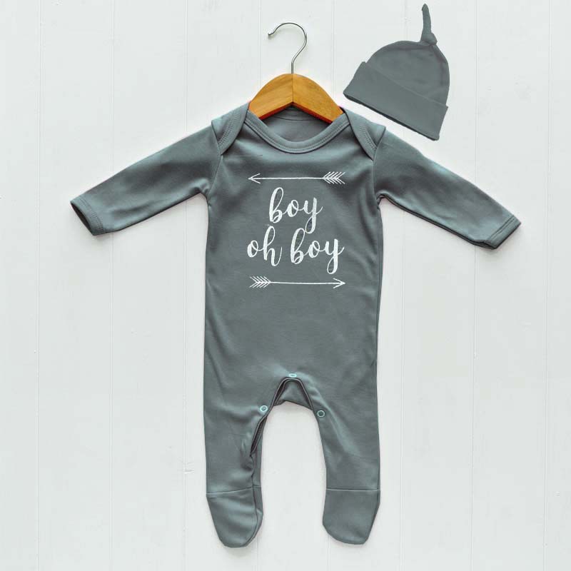 Super soft mid-grey, baby boys clothes set by The Baby Hamper Company. Comprises a 100% cotton hat (age 0-6 months) and 100% cotton sleep suit (0-3 months).  Sleepsuit features our 'Boy Oh Boy' graphic, hipster print to the front.